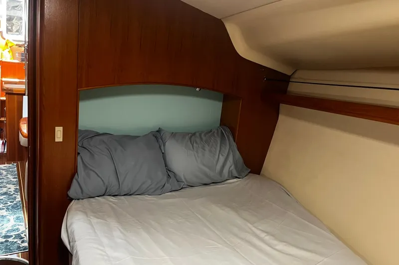 Honu Yacht Photos Pics Cozy cabin interior of 2006 Hunter 41 Deck Salon sailboat with comfortable bedding.