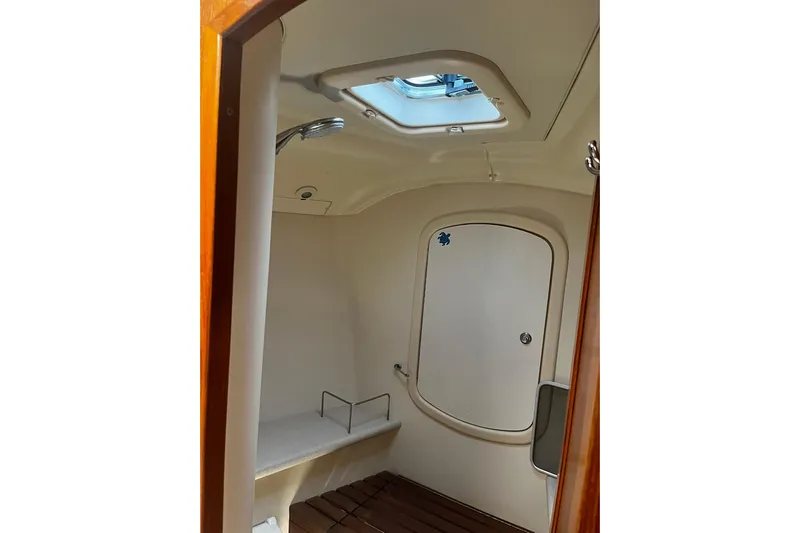 Honu Yacht Photos Pics Interior of 2006 Hunter 41 Deck Salon yacht bathroom with skylight and wooden flooring.
