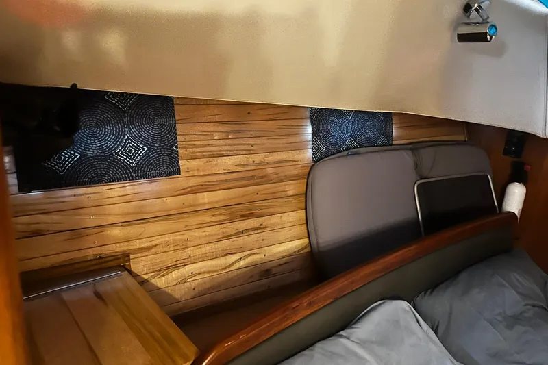 Honu Yacht Photos Pics Interior cabin of 2006 Hunter 41 Deck Salon with wood paneling and cushions.