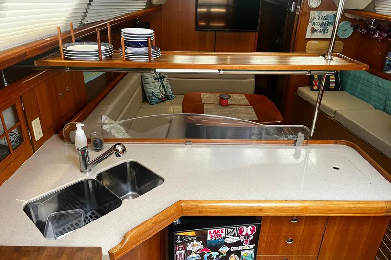 Honu Yacht Photos Pics 2006 Hunter 41 Deck Salon interior with kitchen sink, counter, and dining area.