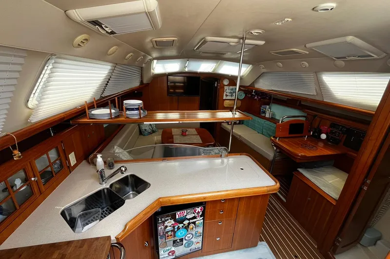 Honu Yacht Photos Pics Interior of 2006 Hunter 41 Deck Salon yacht with modern kitchen and cozy seating area.