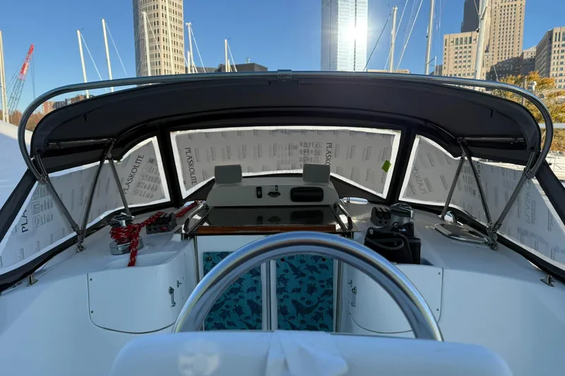 Honu Yacht Photos Pics Interior view of 2006 Hunter 41 Deck Salon sailboat cockpit with city skyline backdrop.