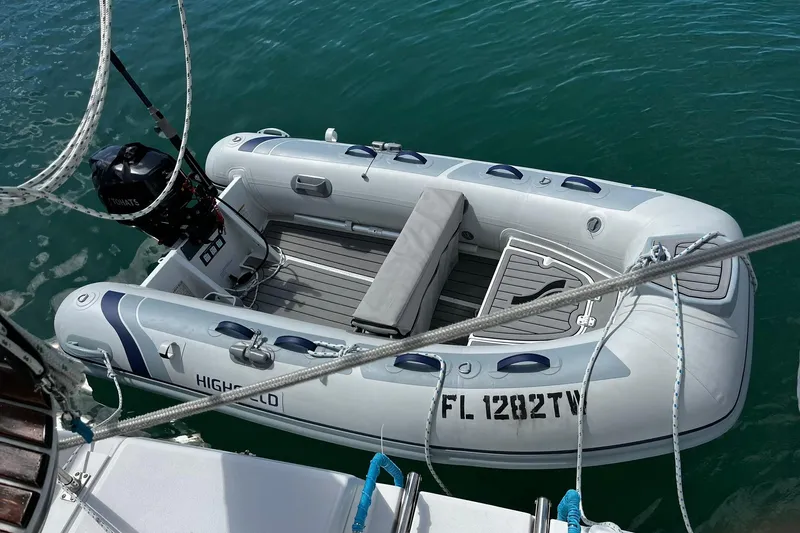 Honu Yacht Photos Pics Inflatable boat with outboard motor, docked beside a 2006 Hunter 41 Deck Salon.
