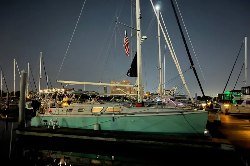 Honu Yacht Photos Pics Sailboat docked at night, 2006 Hunter 41 Deck Salon, illuminated by marina lights.
