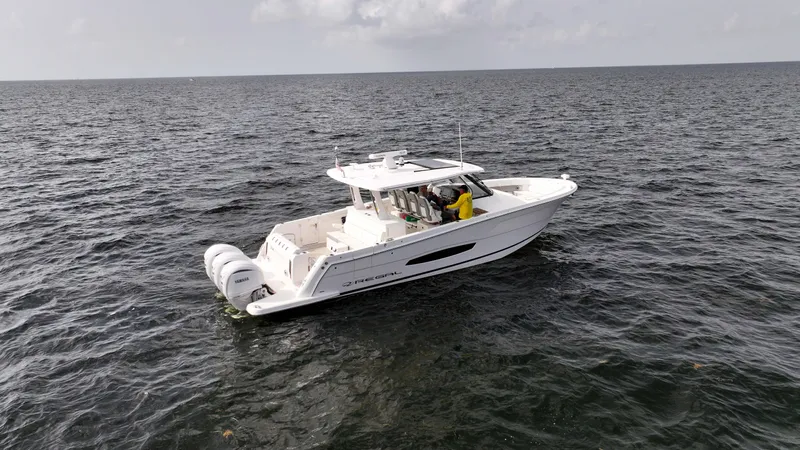  Yacht Photos Pics 2023 Regal 38 SAV boat cruising on open water, featuring twin outboard engines.