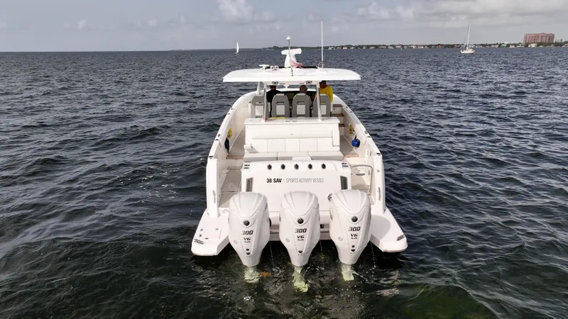  Yacht Photos Pics 2023 Regal 38 SAV boat on open water, rear view with triple engines.