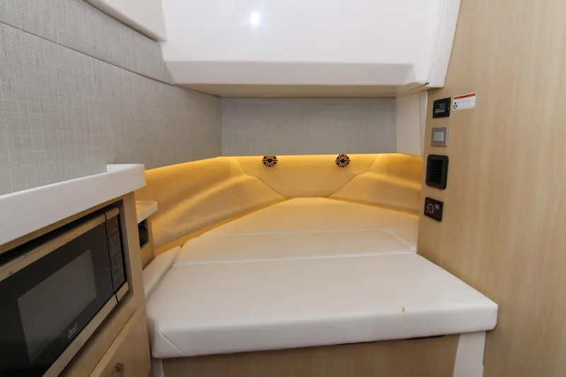  Yacht Photos Pics 2023 Regal 38 SAV interior cabin with cozy seating and modern amenities.