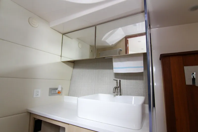  Yacht Photos Pics Modern bathroom interior of 2023 Regal 38 SAV yacht with sleek sink and mirror.
