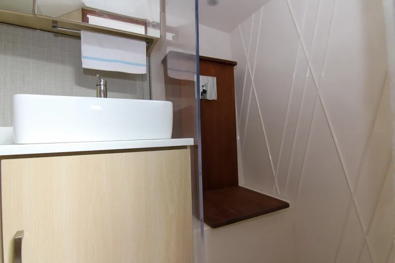  Yacht Photos Pics Modern bathroom interior in 2023 Regal 38 SAV yacht, featuring sleek sink and shower area.