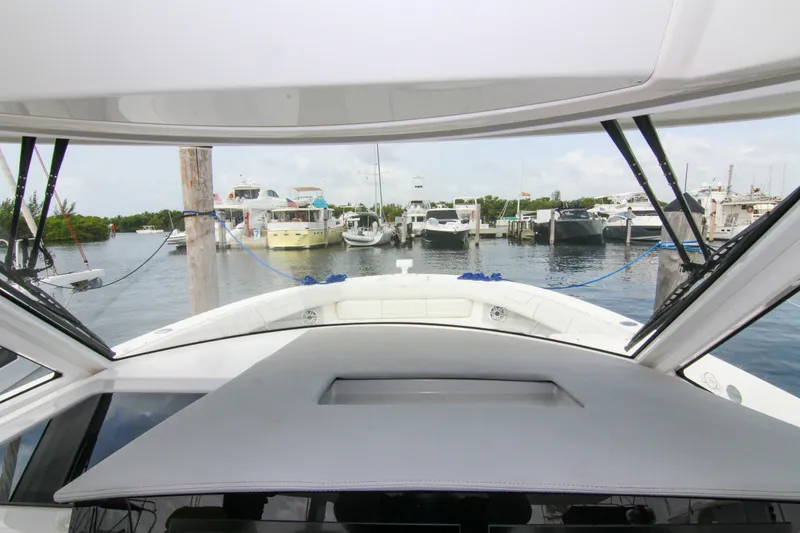  Yacht Photos Pics 2023 Regal 38 SAV yacht docked at a marina with other boats.