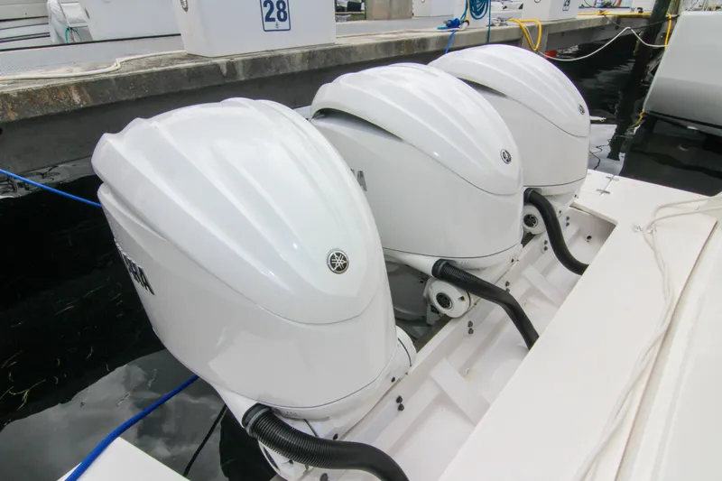  Yacht Photos Pics Triple Yamaha outboard engines on a 2023 Regal 38 SAV boat at a marina.