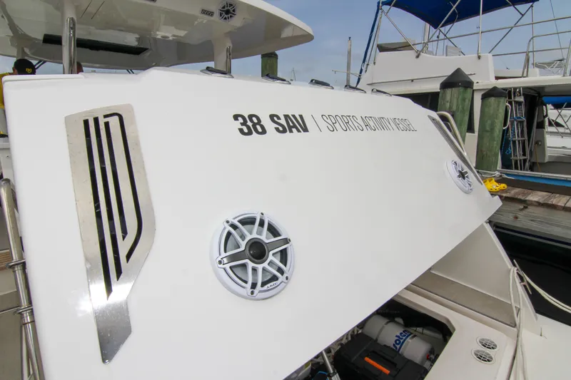  Yacht Photos Pics 2023 Regal 38 SAV boat with open hatch, docked at marina.