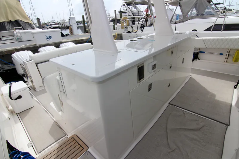  Yacht Photos Pics 2023 Regal 38 SAV yacht interior with sleek white cabinetry and modern design at a marina.