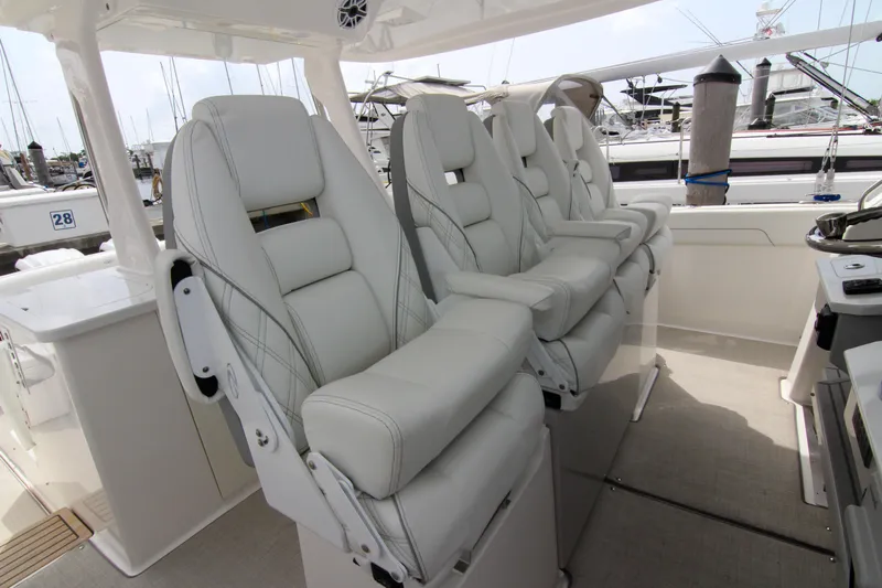  Yacht Photos Pics Luxurious seating on 2023 Regal 38 SAV boat, featuring plush white captain's chairs.