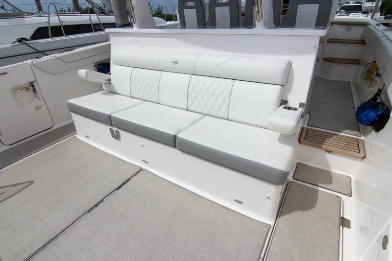  Yacht Photos Pics 2023 Regal 38 SAV boat interior with white cushioned seating and cup holders.
