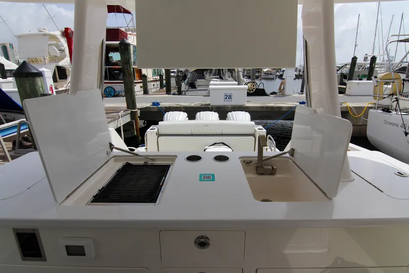  Yacht Photos Pics 2023 Regal 38 SAV boat with outdoor kitchen and sink at marina.