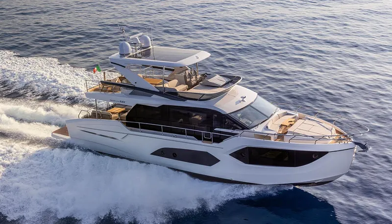  Yacht Photos Pics Luxurious 2026 Absolute 60 Fly yacht cruising on open water, showcasing sleek design and elegance.
