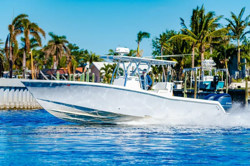  Yacht Photos Pics 2015 Invincible 33 Open Fisherman boat cruising on a sunny day.