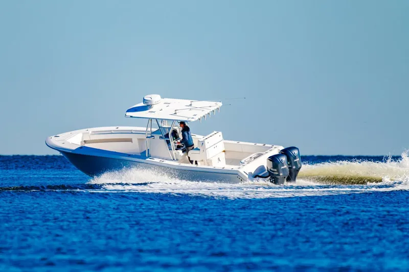  Yacht Photos Pics 2015 Invincible 33 Open Fisherman boat cruising on blue ocean water.