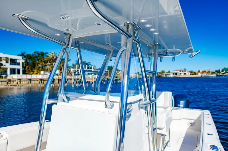  Yacht Photos Pics 2015 Invincible 33 Open Fisherman boat on a sunny waterfront.