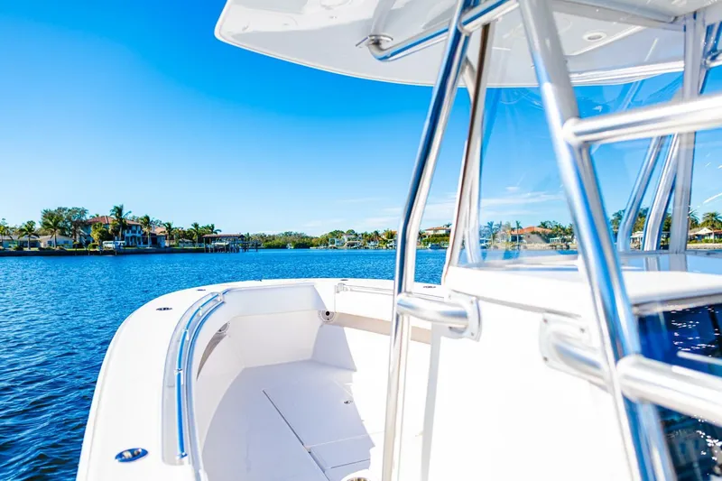  Yacht Photos Pics Invincible 33 Open Fisherman boat on serene blue water, 2015 model.