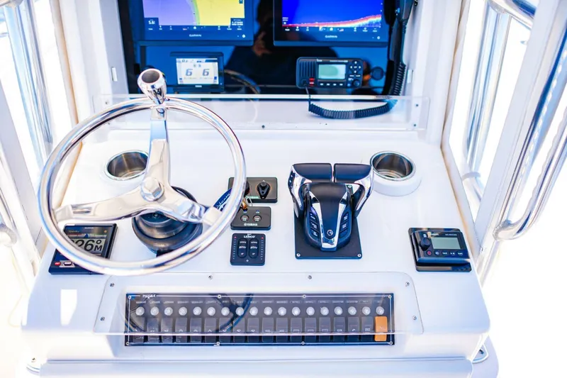  Yacht Photos Pics Invincible 33 Open Fisherman 2015 boat dashboard with steering wheel and navigation controls.