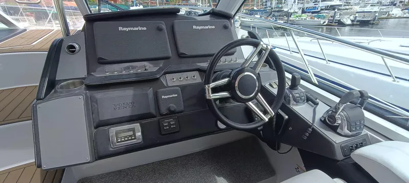 2016 Four Winns H440 Yacht Photos Pics 2016 Four Winns H440 helm with Raymarine electronics and modern steering wheel.