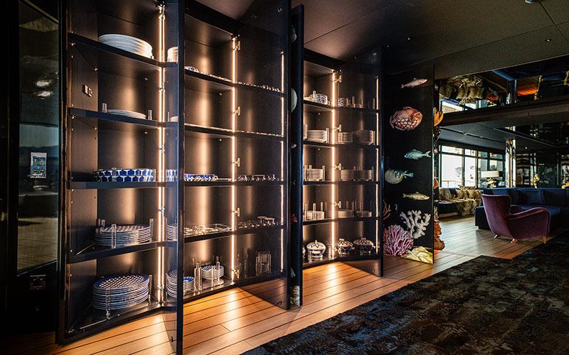 Luxurious interior of 2019 Codecasa F74 yacht with illuminated shelves and elegant decor.