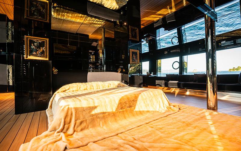 Luxurious bedroom interior on Codecasa F74 yacht, 2019 model, with elegant decor and ocean view.