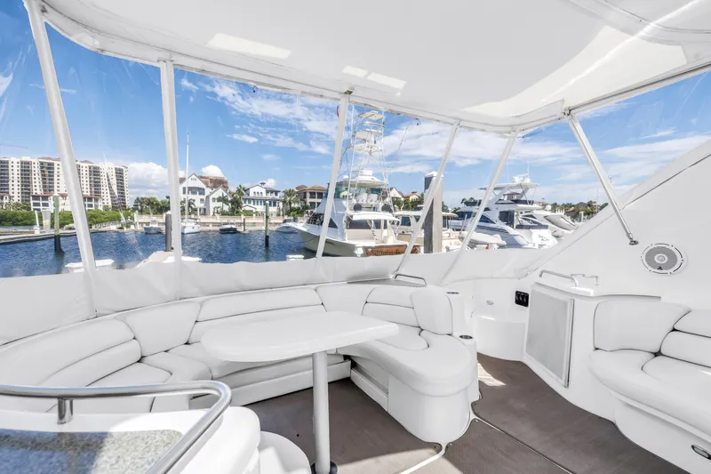  Yacht Photos Pics Luxurious 2002 Cruisers 5370 yacht interior with white seating, marina view, and clear skies.