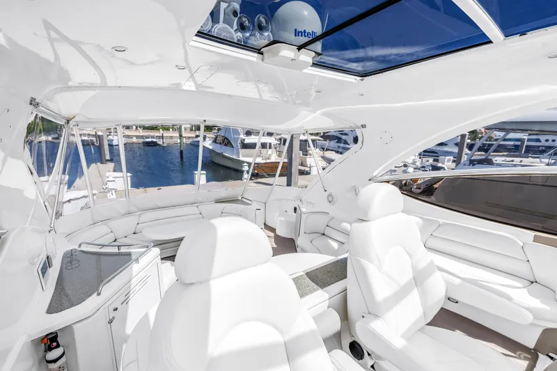  Yacht Photos Pics Luxurious 2002 Cruisers 5370 yacht interior with white seating and panoramic marina view.