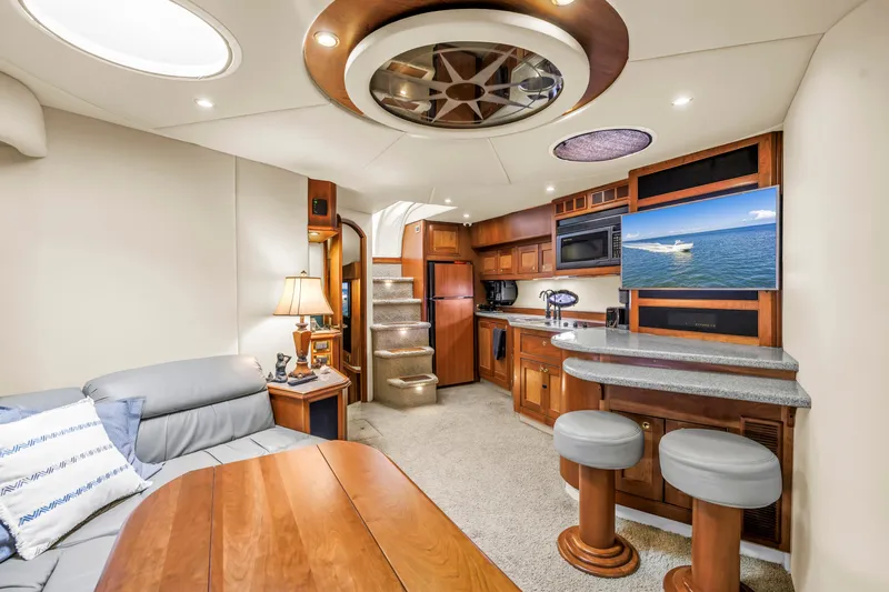  Yacht Photos Pics Luxurious 2002 Cruisers 5370 yacht interior with modern kitchen, seating, and entertainment area.