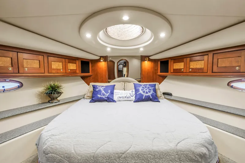  Yacht Photos Pics Luxurious 2002 Cruisers 5370 yacht bedroom with elegant wood cabinetry and nautical decor.