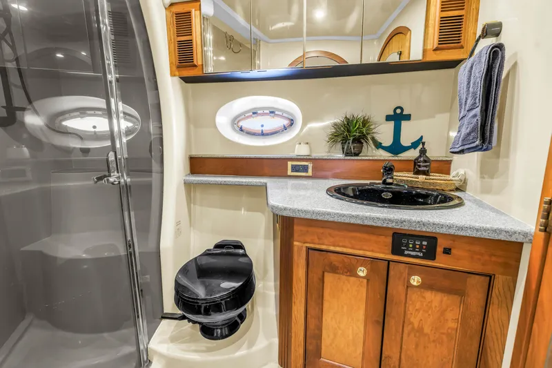  Yacht Photos Pics Luxurious 2002 Cruisers 5370 yacht bathroom with modern amenities and nautical decor.