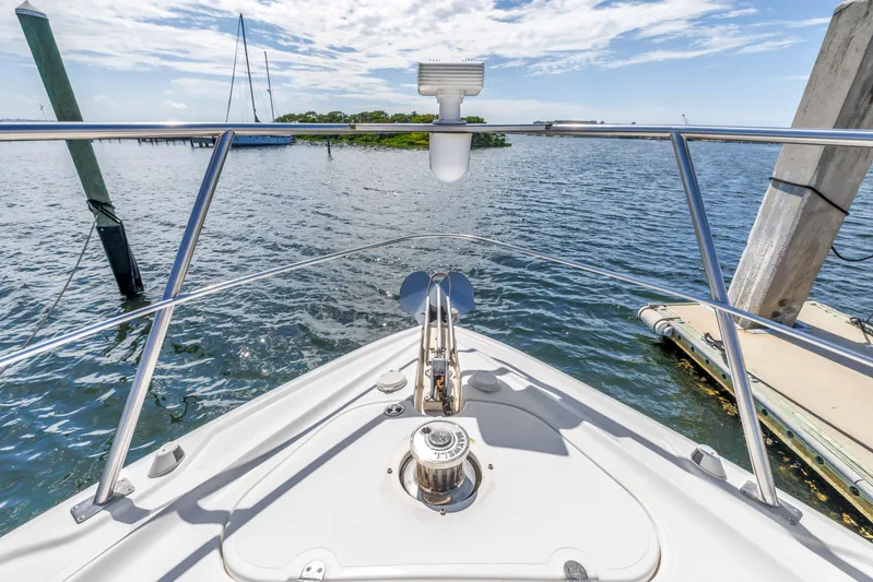  Yacht Photos Pics Bow view of 2002 Cruisers 5370 yacht on calm water under blue sky.