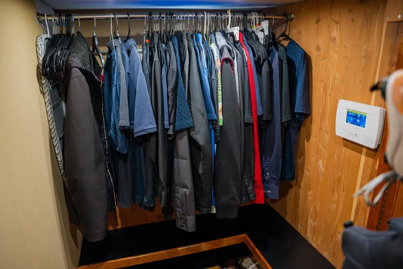  Yacht Photos Pics Clothing closet in 2002 Cruisers 5370 yacht with wooden paneling and control panel.