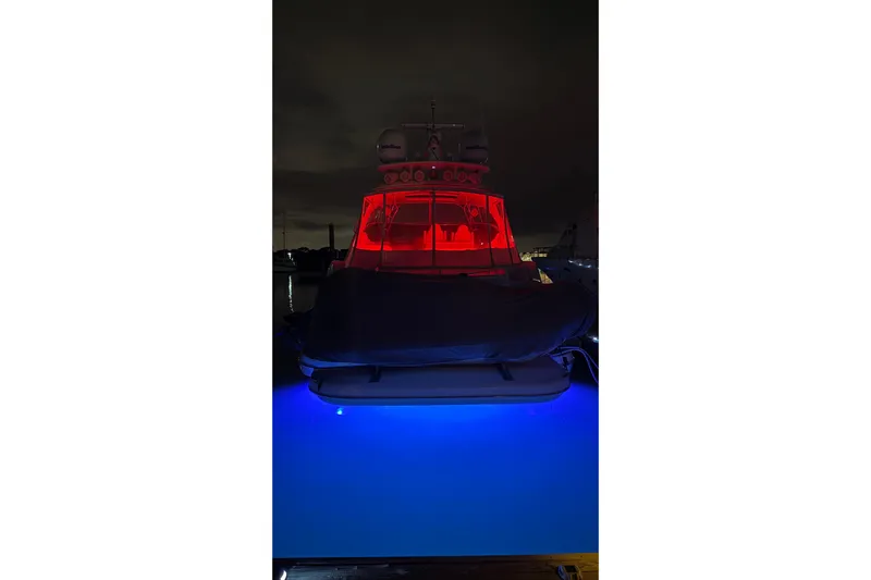  Yacht Photos Pics 2002 Cruisers 5370 yacht with red and blue lights at night.