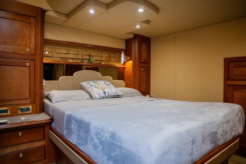  Yacht Photos Pics Luxurious 2002 Cruisers 5370 yacht bedroom with elegant wood cabinetry and plush bedding.