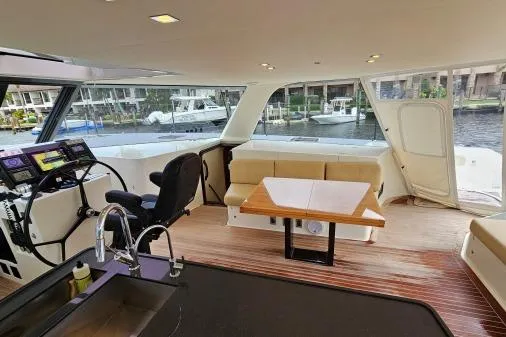 Vandal Yacht Photos Pics Interior of 2014 Gunboat 55 yacht with modern helm, seating, and waterfront view.