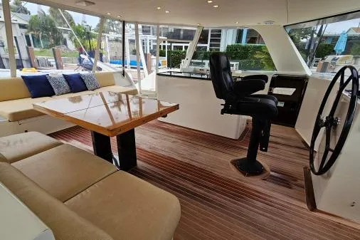 Vandal Yacht Photos Pics Interior of 2014 Gunboat 55 yacht with seating, table, and steering wheel.