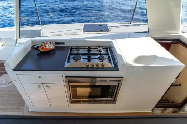 Vandal Yacht Photos Pics Outdoor kitchen on 2014 Gunboat 55 yacht with stove, microwave, and ocean view.