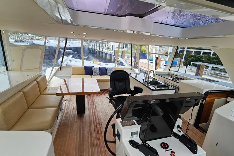 Vandal Yacht Photos Pics Luxurious interior of 2014 Gunboat 55 yacht with helm, seating, and dining area.