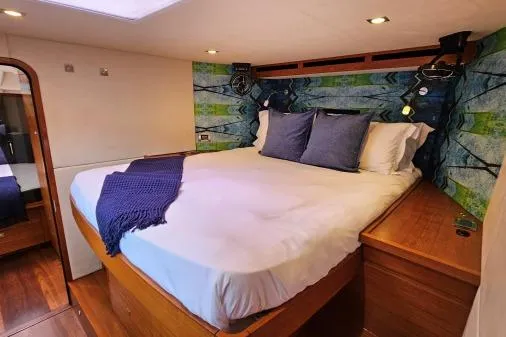 Vandal Yacht Photos Pics Luxurious cabin interior of 2014 Gunboat 55 with cozy bed and vibrant decor.