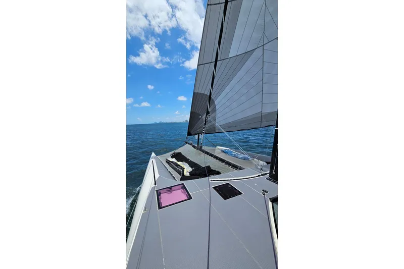 Vandal Yacht Photos Pics Sailing on a 2014 Gunboat 55 catamaran under clear blue skies.