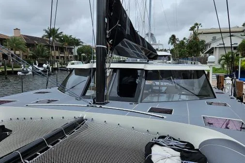 Vandal Yacht Photos Pics 2014 Gunboat 55 catamaran docked in a marina, showcasing sleek design and spacious deck.