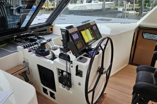 Vandal Yacht Photos Pics Cockpit of 2014 Gunboat 55 yacht with navigation controls and steering wheel.