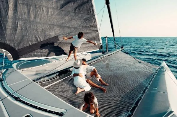 Vandal Yacht Photos Pics Family enjoying a day on a 2014 Gunboat 55 catamaran, sailing on open sea.