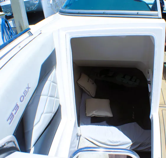 Sea M.a.j.i.c. Yacht Photos Pics 2022 Regal 33 OBX boat cabin interior with cushions and seating.