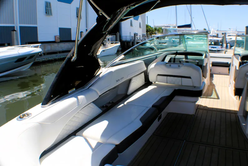 Sea M.a.j.i.c. Yacht Photos Pics 2022 Regal 33 OBX boat with luxurious seating and sleek design at a marina.