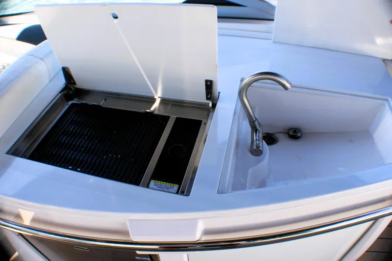 Sea M.a.j.i.c. Yacht Photos Pics 2022 Regal 33 OBX boat kitchenette with sink and grill.